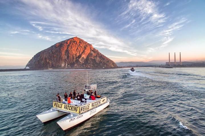 a boat on a body of water with a mountain in the background